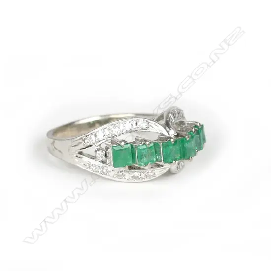 An 18ct. white gold emerald and diamond ring