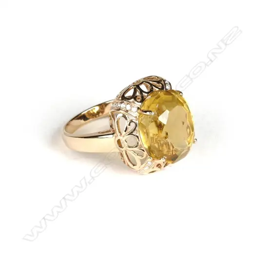 An 18ct. yellow gold large citrine and diamond dress ring