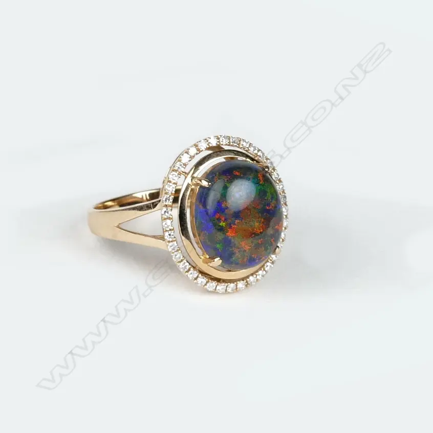 An 18ct. rose gold opal and diamond dress ring Image 1++
