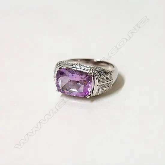 A lady's modern 18ct. white gold amethyst and diamond dress ring
