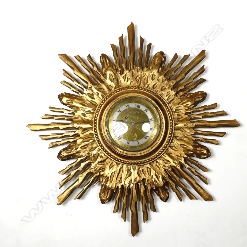 A vintage sunburst framed clock Image 1++