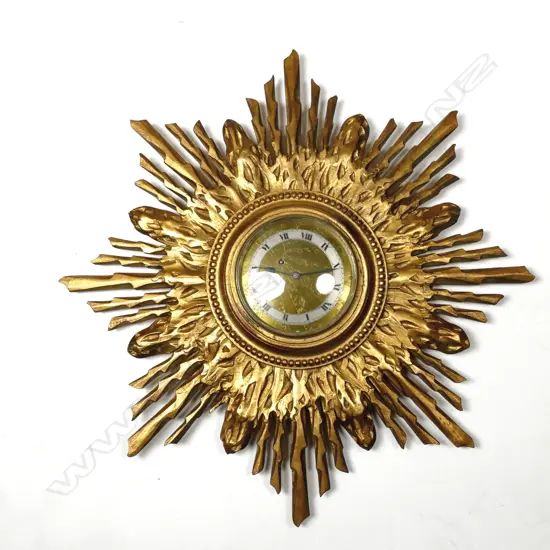 A vintage sunburst framed clock