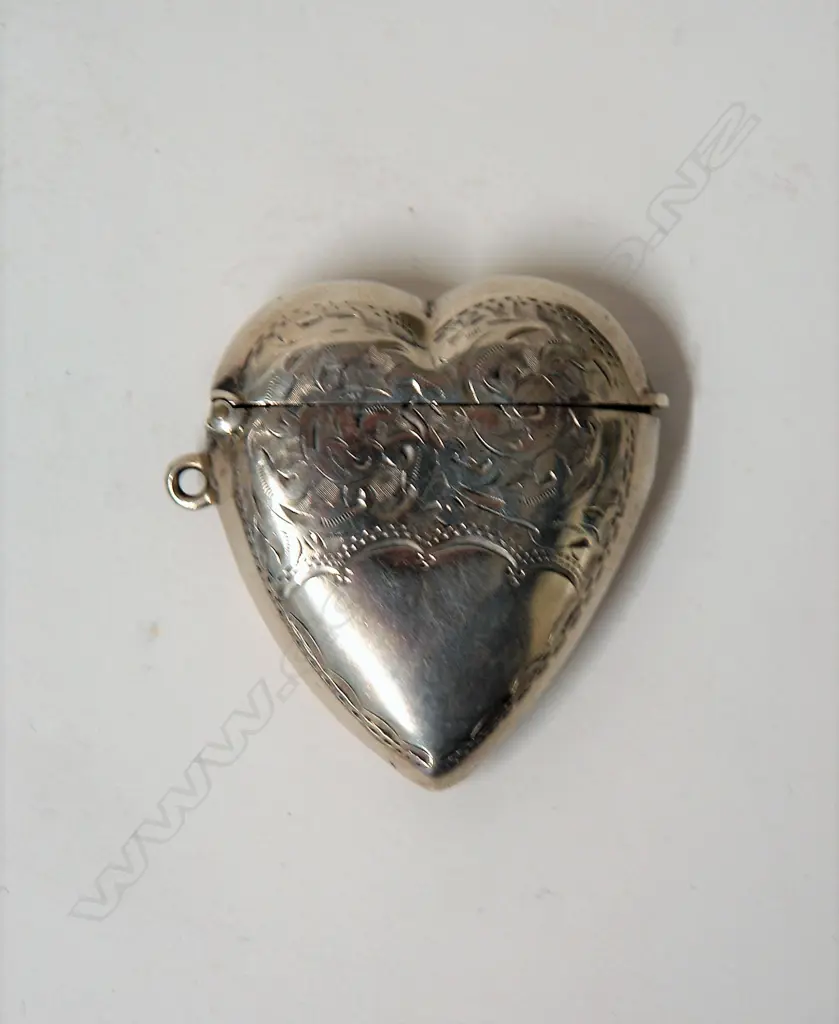 A late Victorian silver heart form engraved vesta Image 1++
