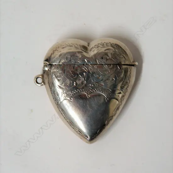 A late Victorian silver heart form engraved vesta