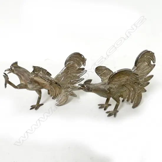 A pair of .950 silver filigree fighting cockerels