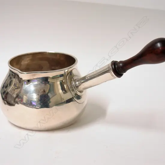 A rare and large Queen Anne silver brandy saucepan