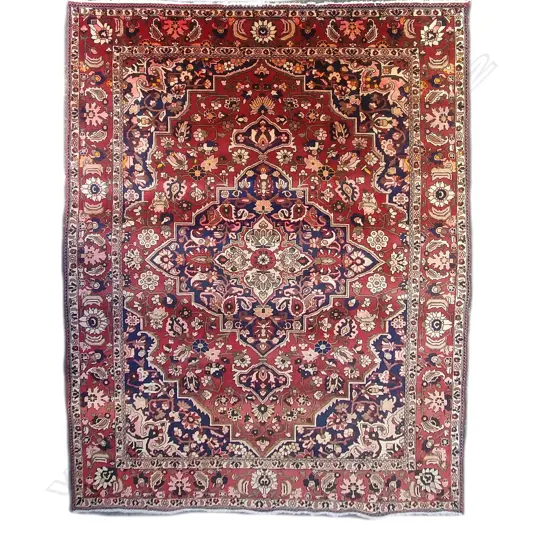 A large hand knotted Persian Heriz carpet