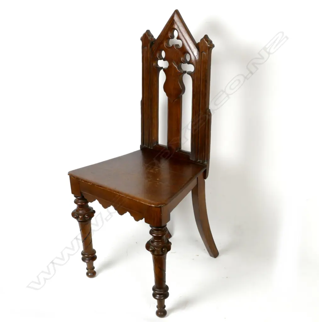 A Victorian oak hall chair with carved and pierced decoration Image 1++