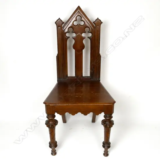 A Victorian oak hall chair with carved and pierced decoration