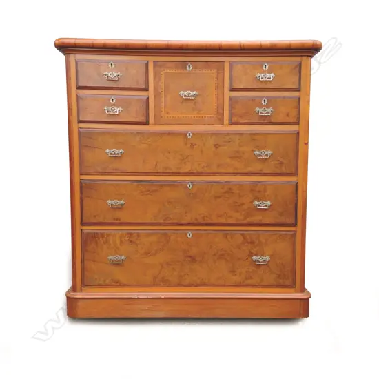 A colonial mottled kauri and rewarewa eight drawer scotch chest