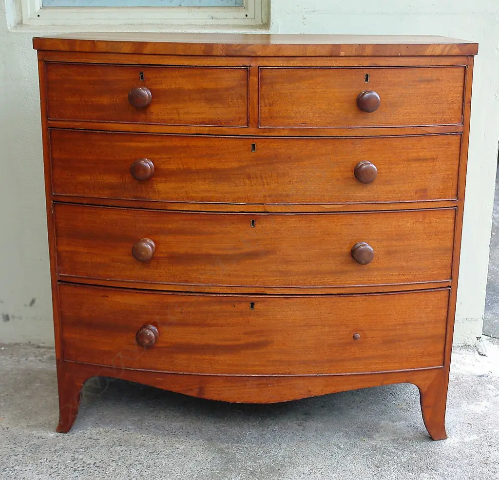 A late Georgian mahogany bowfront chest of five drawers Image 1++