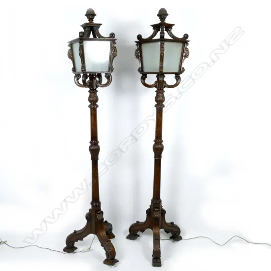 An ornate and unusual pair of vintage mahogany standing lanterns