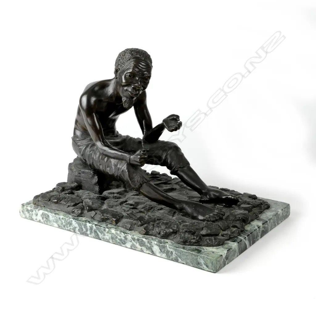 A bronze figure of a seated South African bushman holding pipe Image 1++
