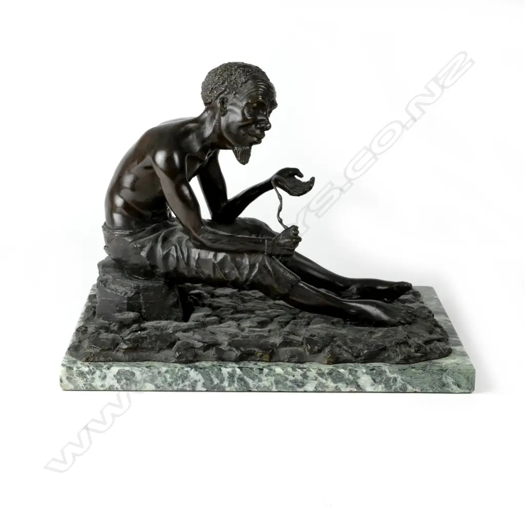 A bronze figure of a seated South African bushman holding pipe Image 1++