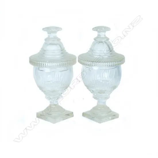 A pair of Georgian cut crystal lidded sweetmeat containers