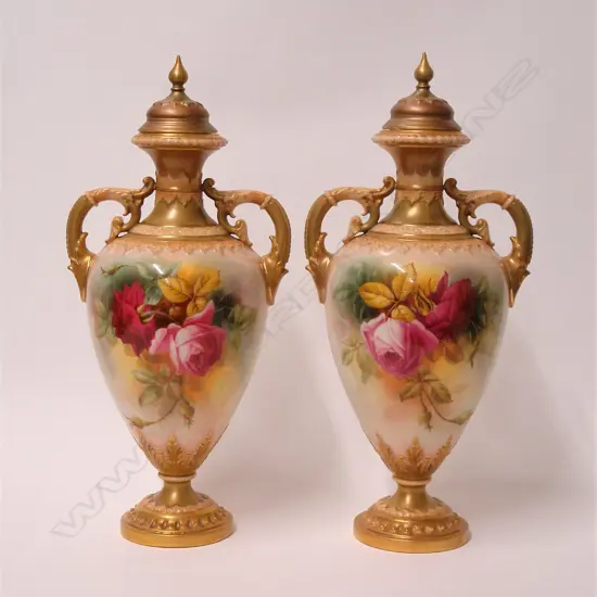 A pair of early 20thC Royal Worcester rose painted lidded urns by W. Hart