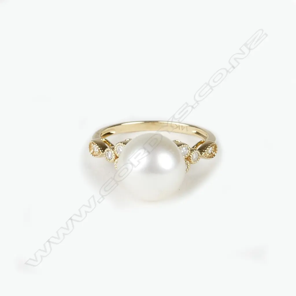 A 14ct. yellow gold diamond and pearl ring Image 1++