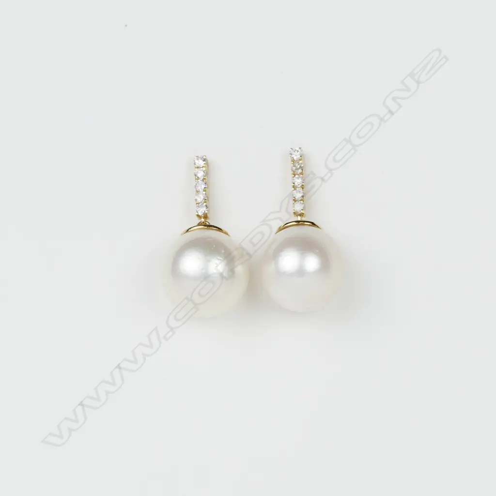 A 14ct. yellow gold diamond and pearl drop earrings Image 1++