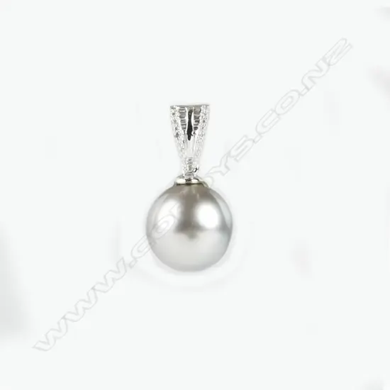An 18ct. white gold diamond and pearl pendant