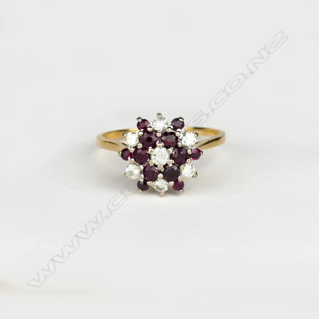 An 18ct. gold ruby and diamond cluster ring Image 1++