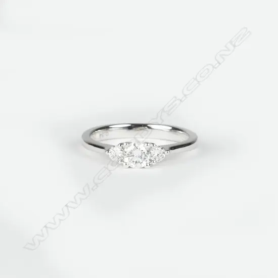 A 9ct. white gold and diamond trilogy ring