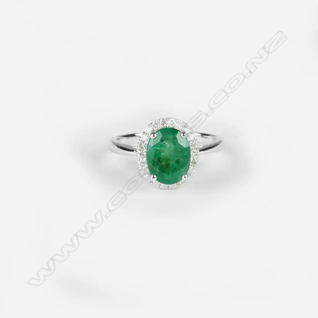 A 14ct. white gold emerald and diamond ring Image 1++