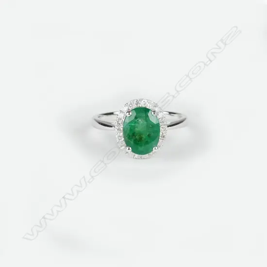 A 14ct. white gold emerald and diamond ring