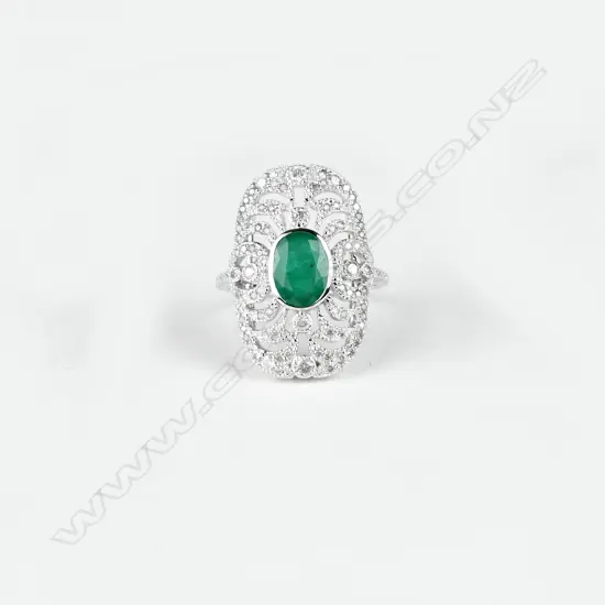 An 18ct. white gold emerald and diamond Art Deco style ring