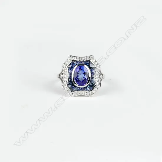 An 18ct. white gold tanzanite sapphire and diamond ring