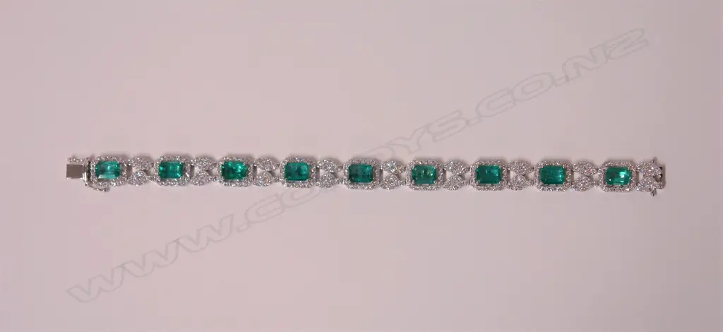 An impressive classical 18ct. white gold modern emerald and diamond bracelet Image 1++