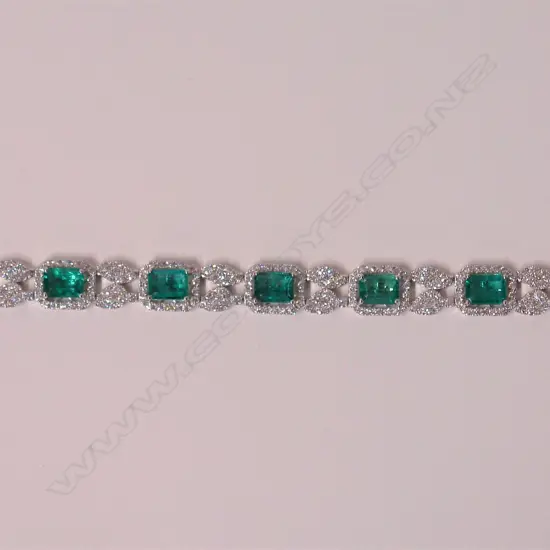 An impressive classical 18ct. white gold modern emerald and diamond bracelet