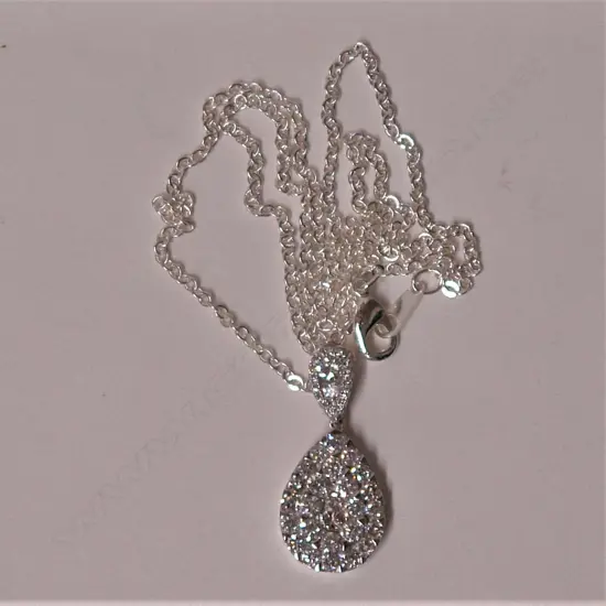 A modern 18ct. white gold and diamond encrusted pendant on chain