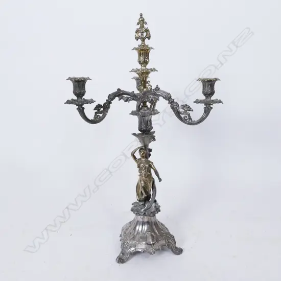 An ornate silver plate and parcel gilt candelabra