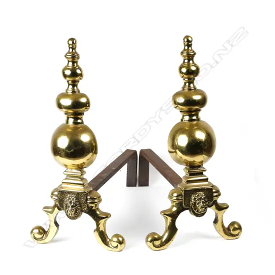 A pair of Regency brass firedogs