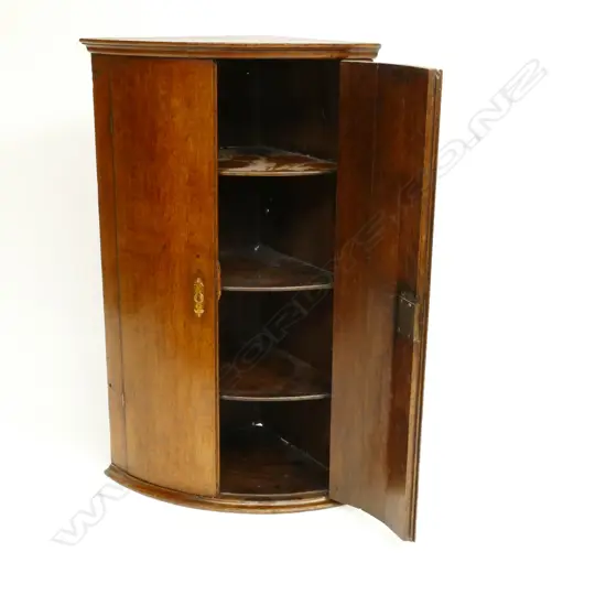 A Georgian oak corner cabinet