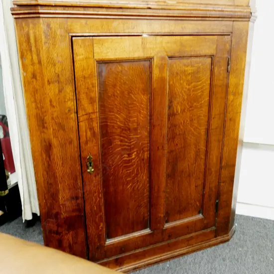A Georgian oak corner cabinet