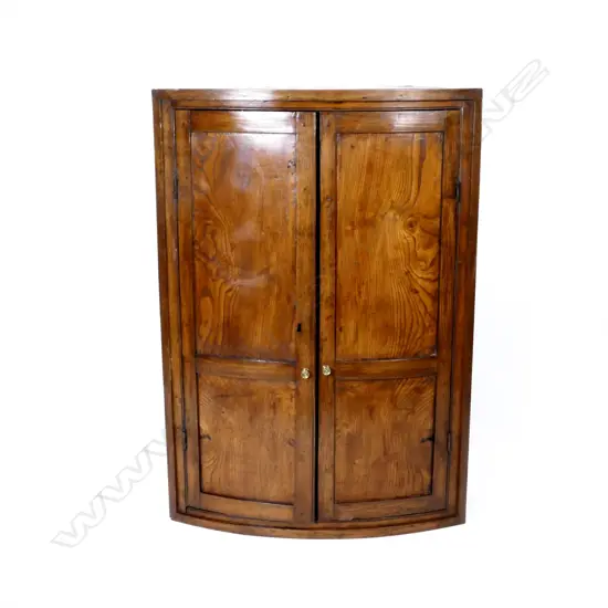 A Georgian oak corner cabinet