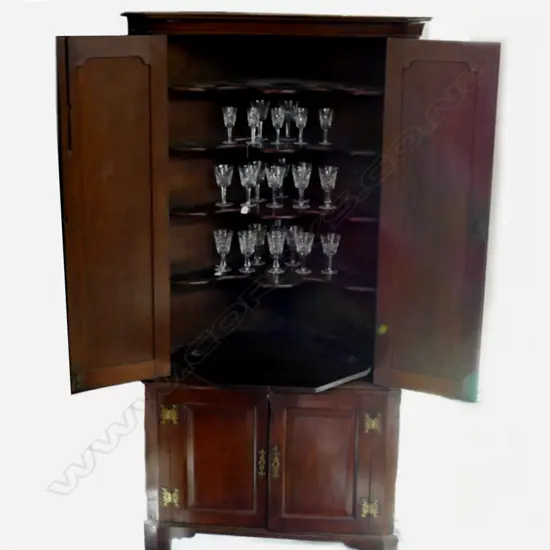 An impressive Georgian oak standing corner cabinet