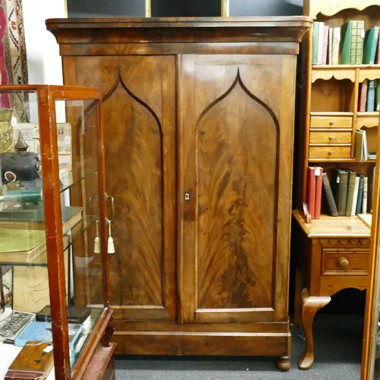 A Regency flame mahogany and oak small cupboard