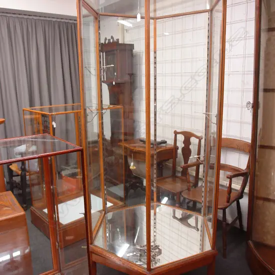 A 1920/1930s rare tall hexagonal oak framed and glazed shop display cabinet