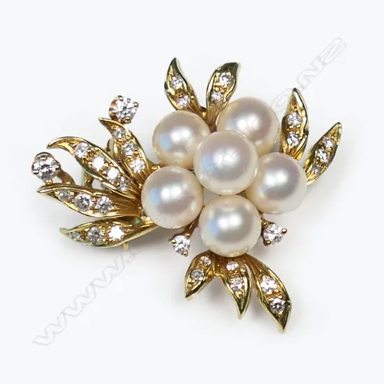 An 18ct yellow gold diamond and pearl spray brooch/clip,