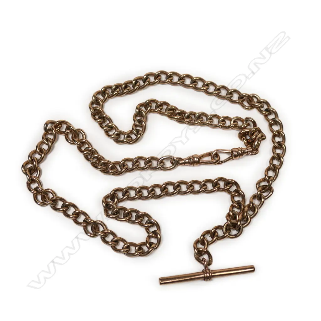An early 20thC 9ct rose gold long Albert chain uniform curb links with T-bar and pair of clips. L.520mm. 42gm. Image 1++