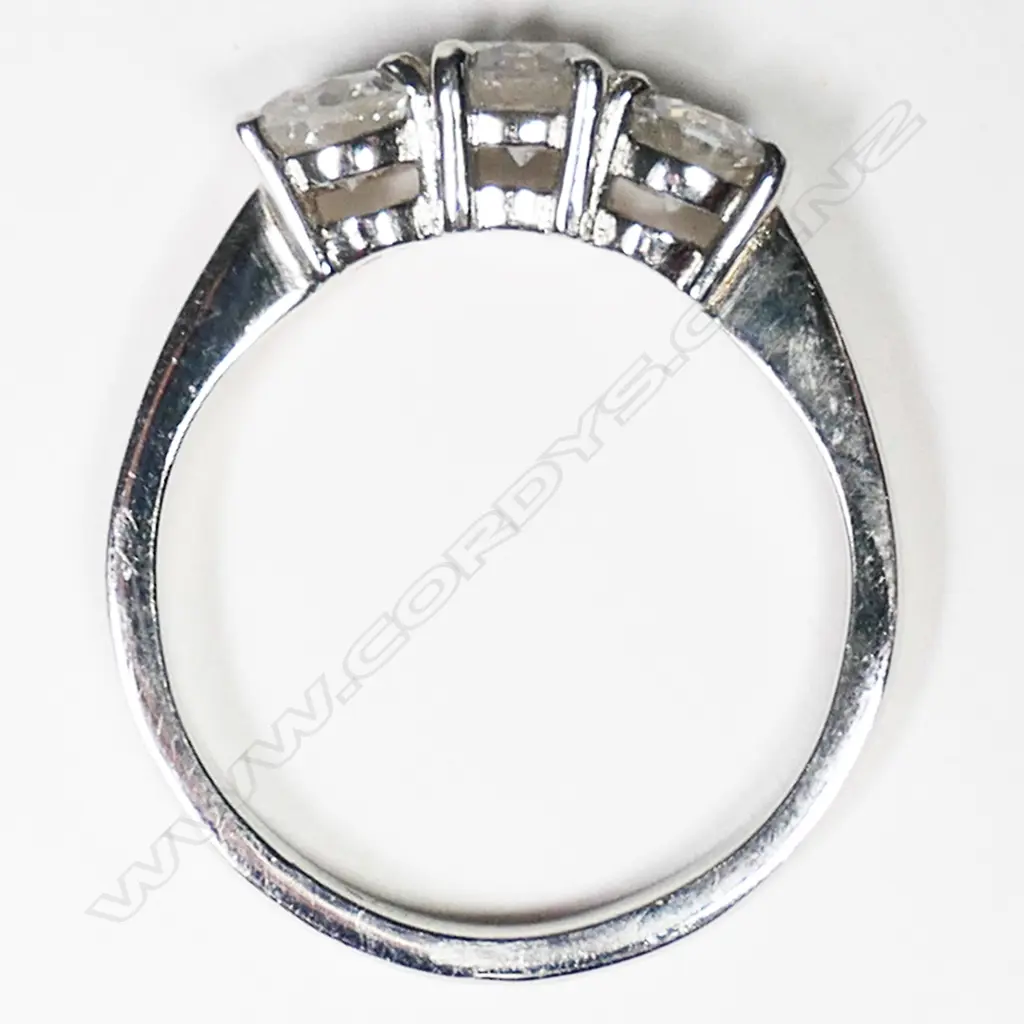 A platinum and three stone diamond ring, Image 1++