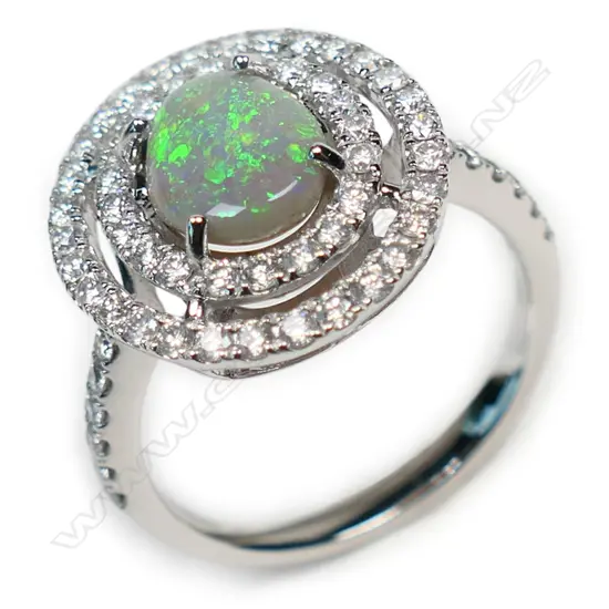 A 14ct white gold opal and diamond double halo ring,
