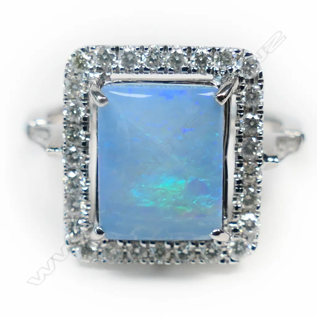 A 14ct white gold opal and diamond halo ring, Image 1++