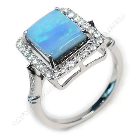 A 14ct white gold opal and diamond halo ring,
