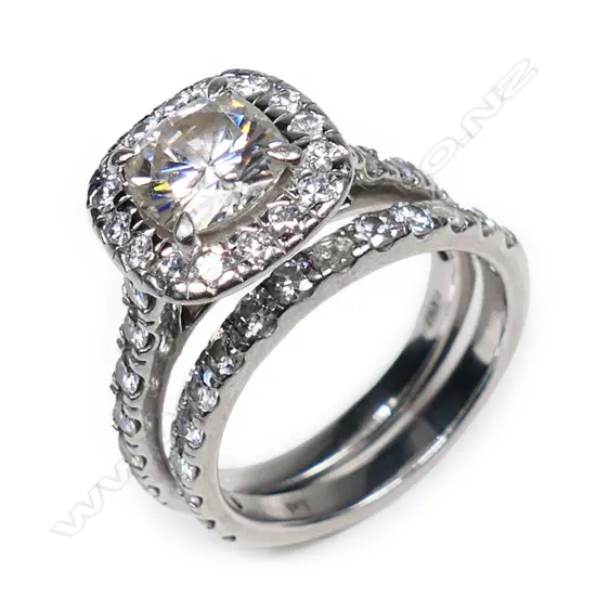 A pair of platinum and moissanite rings,