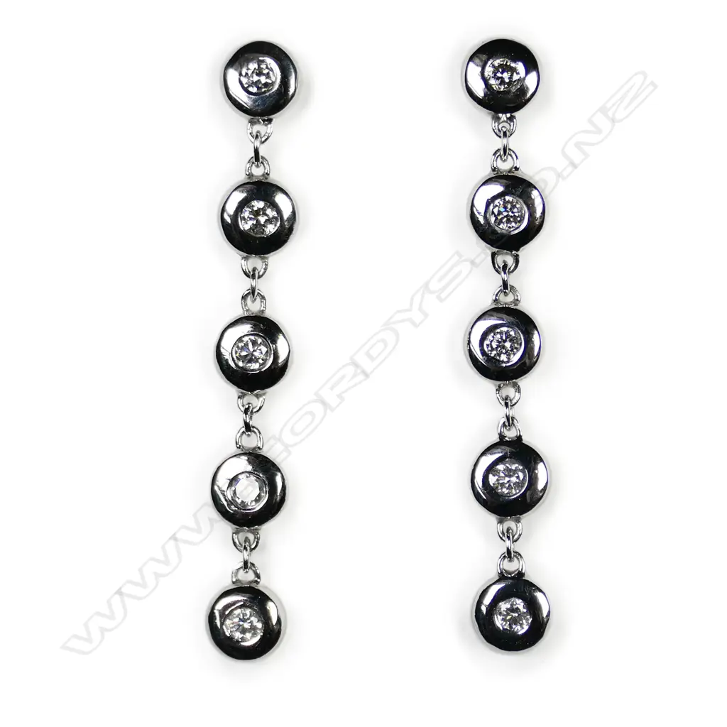 A pair of 9ct white gold and diamond drop earrings, Image 1++