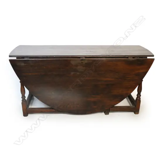 A large Georgian oak gate leg table,
