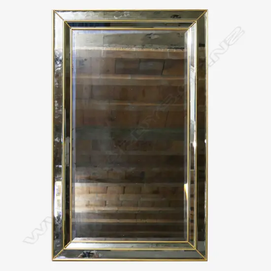 A large contemporary cushion mirror,